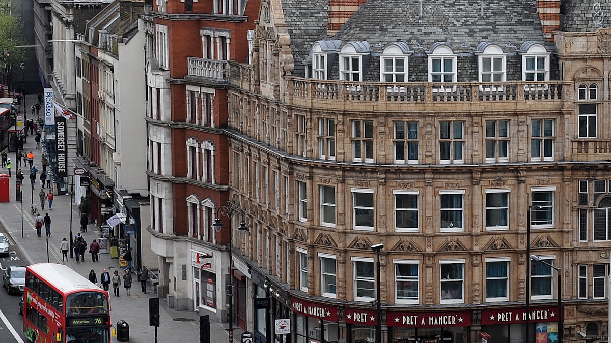 Red double-decker buses on a busy London street